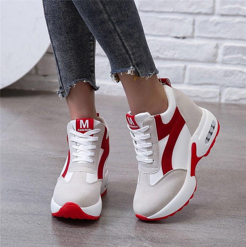 Modern red and black platform sneaker heels with air cushion soles and lace-up design