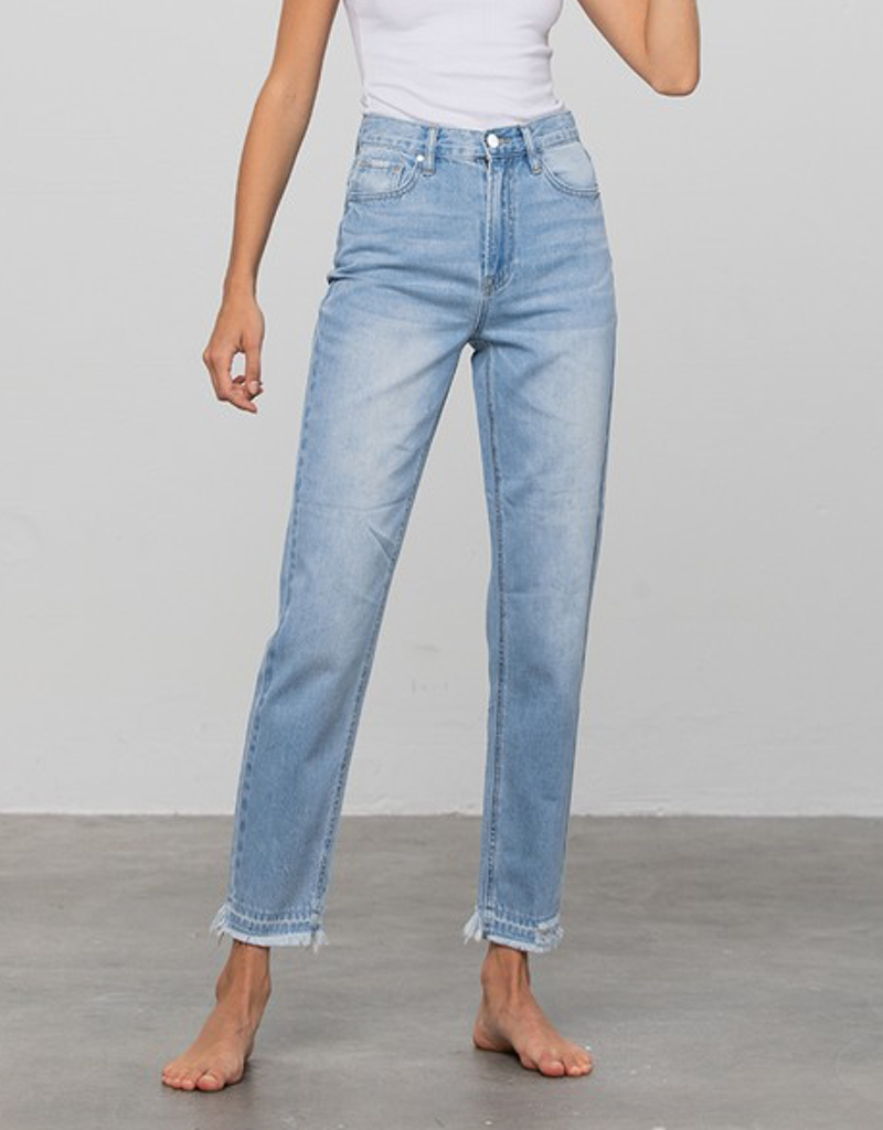 Model wearing light blue high-rise premium girlfriend jeans with a relaxed tapered fit
