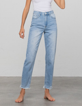 Model wearing light blue high-rise premium girlfriend jeans with a relaxed tapered fit