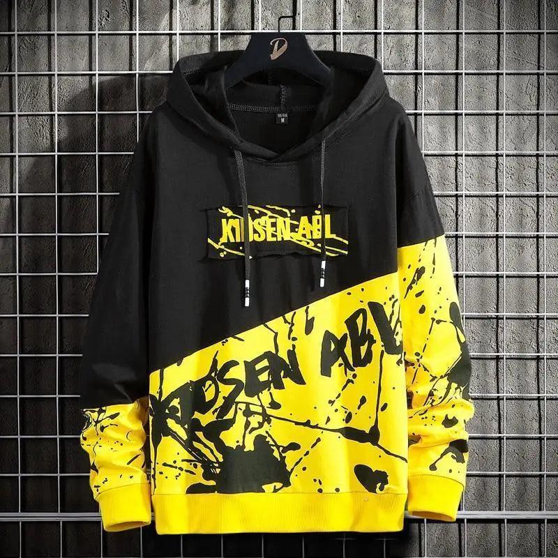 Men's oversized black streetwear hoodie with vibrant yellow abstract print and hood