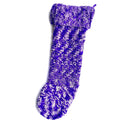 Handmade crochet Christmas stocking in variegated purple and white yarn displayed in a traditional living room.