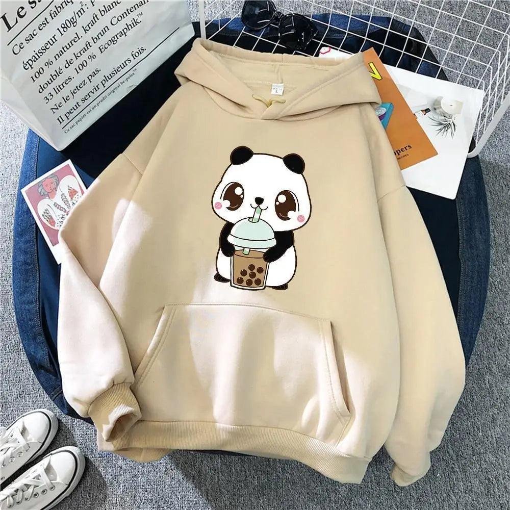 Woman wearing an oversized graphic streetwear hoodie in a casual winter outfit.