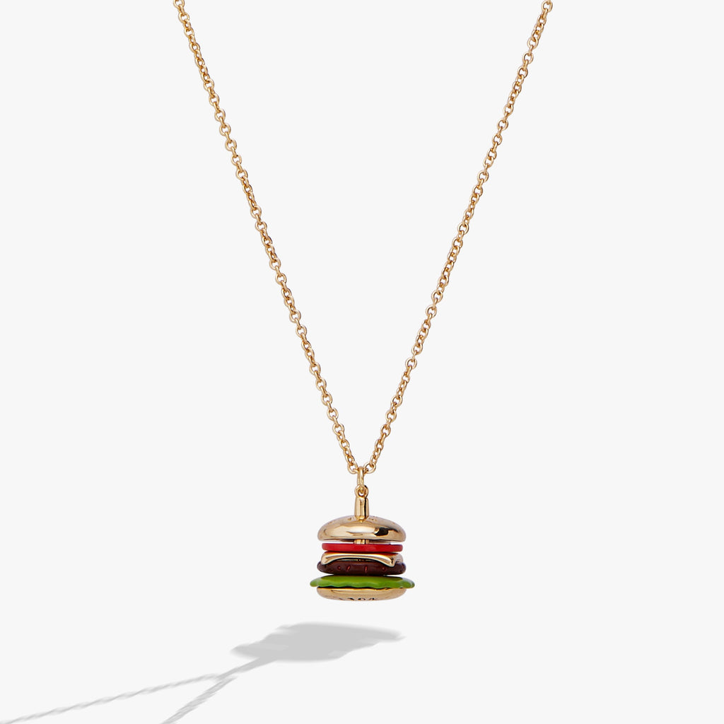 Close up of a hamburger shaped pendant charm with vibrant enamel on a gold cable chain.