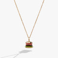 Close up of a hamburger shaped pendant charm with vibrant enamel on a gold cable chain.