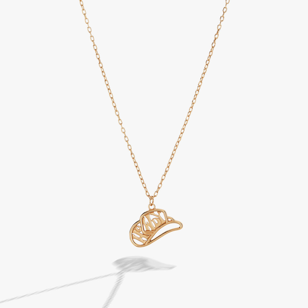 Gold Howdy necklace featuring a cowboy hat charm, perfect for western-inspired bohemian jewelry looks.