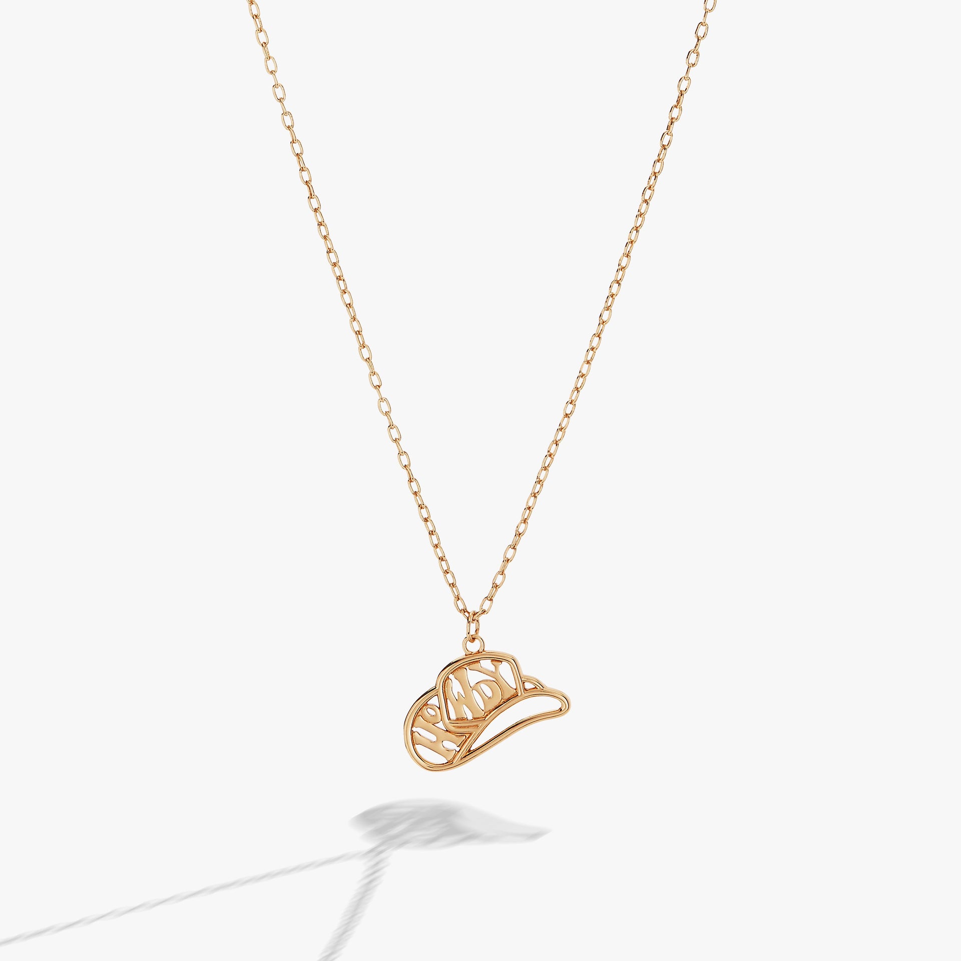 Gold Howdy necklace featuring a cowboy hat charm, perfect for western-inspired bohemian jewelry looks.