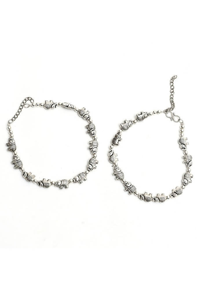Detailed view of oxidised silver anklets with elephant design motifs