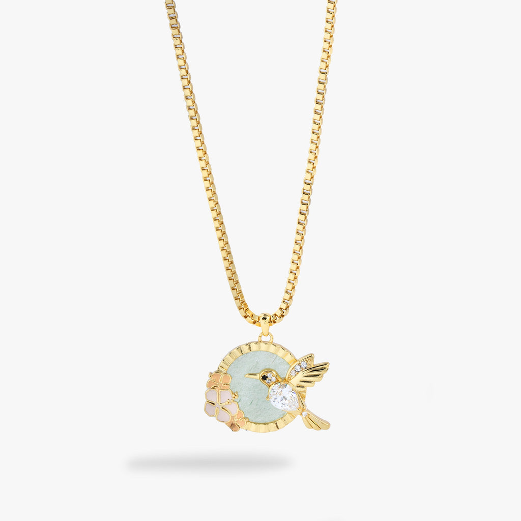 Hummingbird pendant necklace featuring a green aventurine gemstone, gold hummingbird charm, and peach enamel flowers.