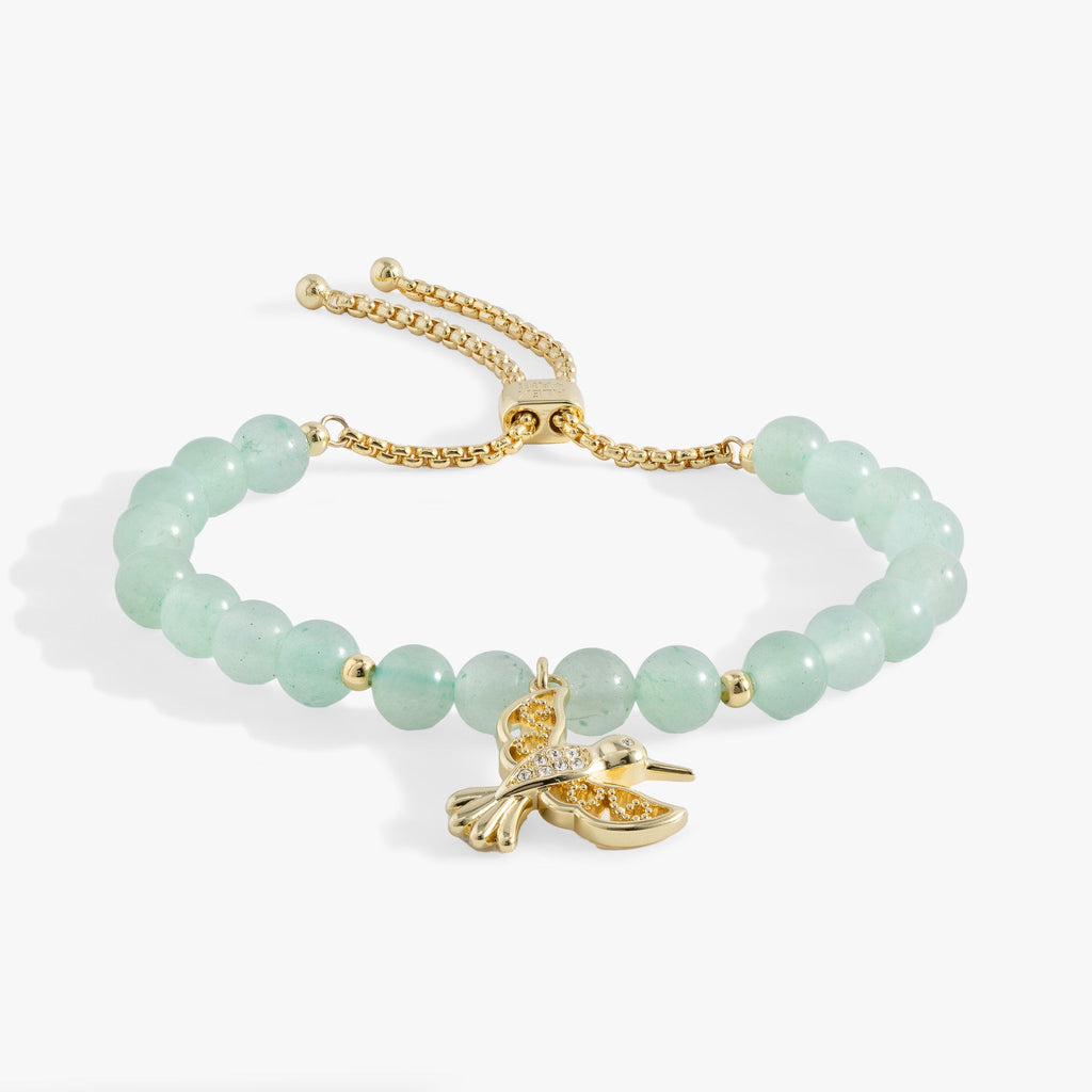 Hummingbird bolo bracelet featuring green aventurine beads and a crystal-encrusted hummingbird charm in a gold-tone finish.