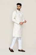 Cream colored jacquard silk kurta with matching straight fit trousers