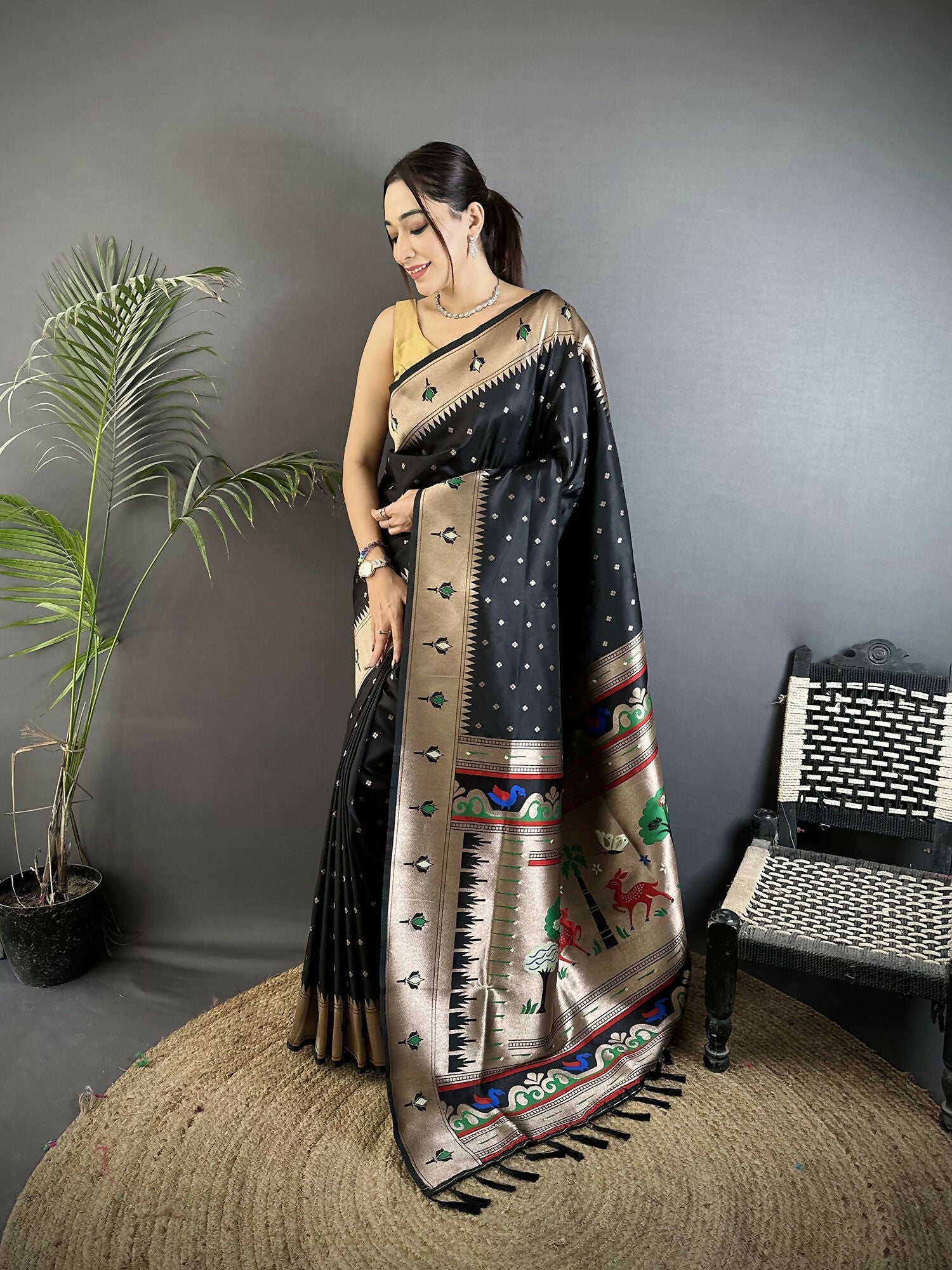 Black soft Lichi silk Kanchipuram saree with peacock and floral motifs and matching blouse