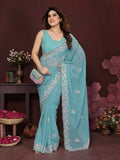 Vibrant turquoise georgette saree featuring intricate embroidery and matching blouse
