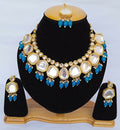 Blue Kundan necklace set with gold-plated finish and stone detailing on a plain background