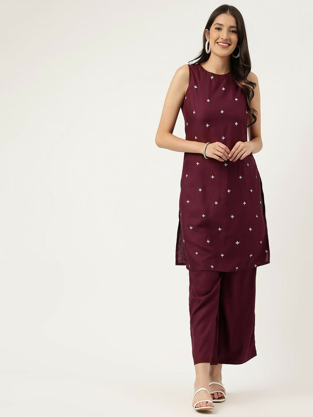 A maroon rayon straight kurta set with white embroidery, sleeveless design, and ankle-length cut.