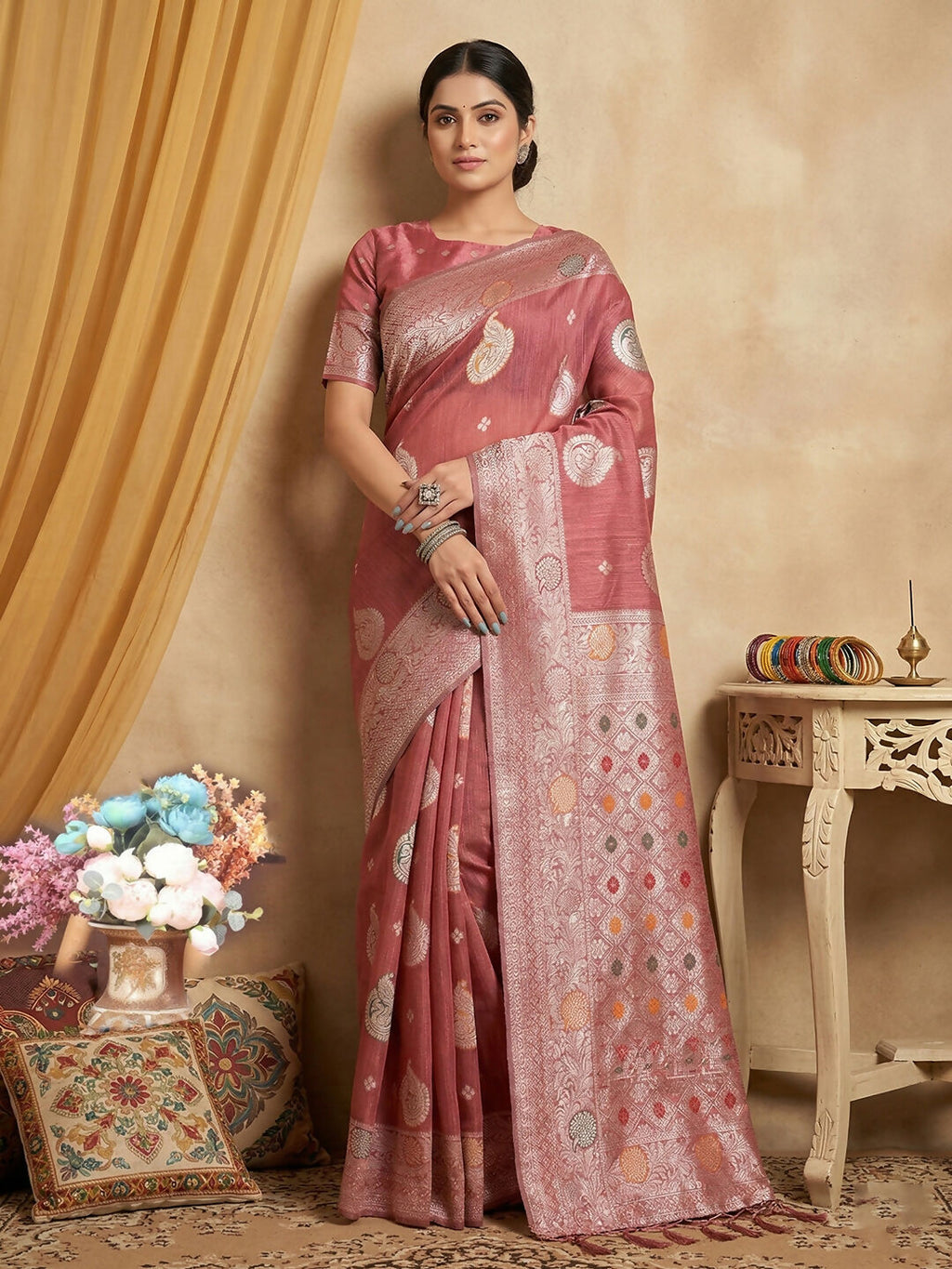 A beautiful pink linen cotton saree with a matching blouse piece.