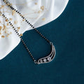 A close-up view of a Joban Fashion white American Diamond mangalsutra with brass setting.