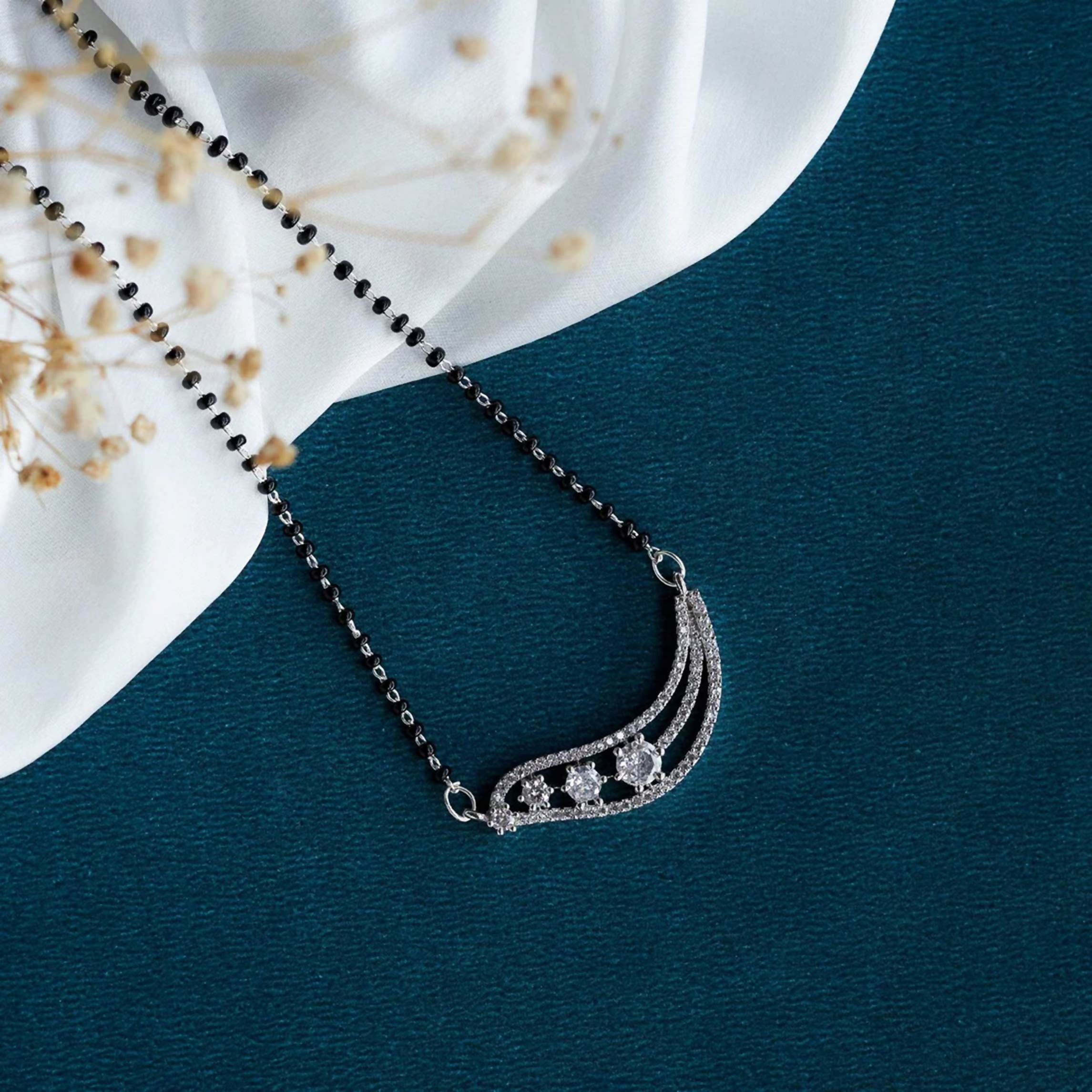 A close-up view of a Joban Fashion white American Diamond mangalsutra with brass setting.