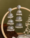 Close-up of traditional silver Maithili Jhumki earrings with pearl details on a model