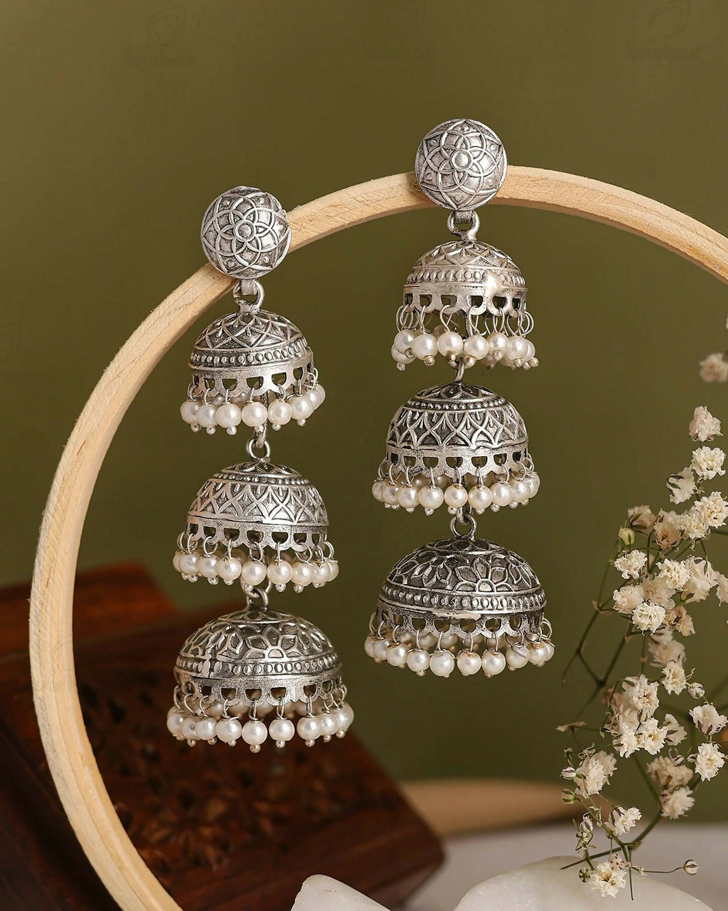 Close-up of traditional silver Maithili Jhumki earrings with pearl details on a model