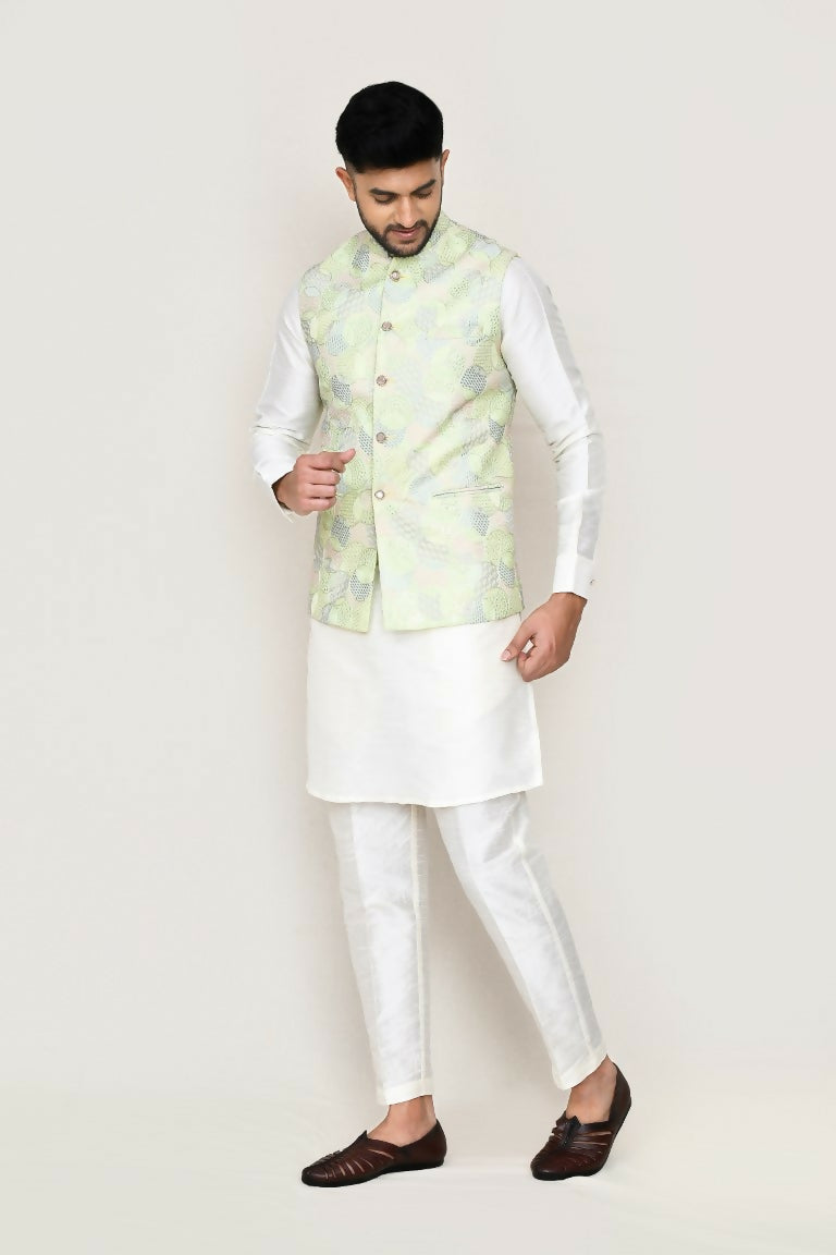 Man wearing a white art silk kurta paired with a matching jacket and straight fit pants.