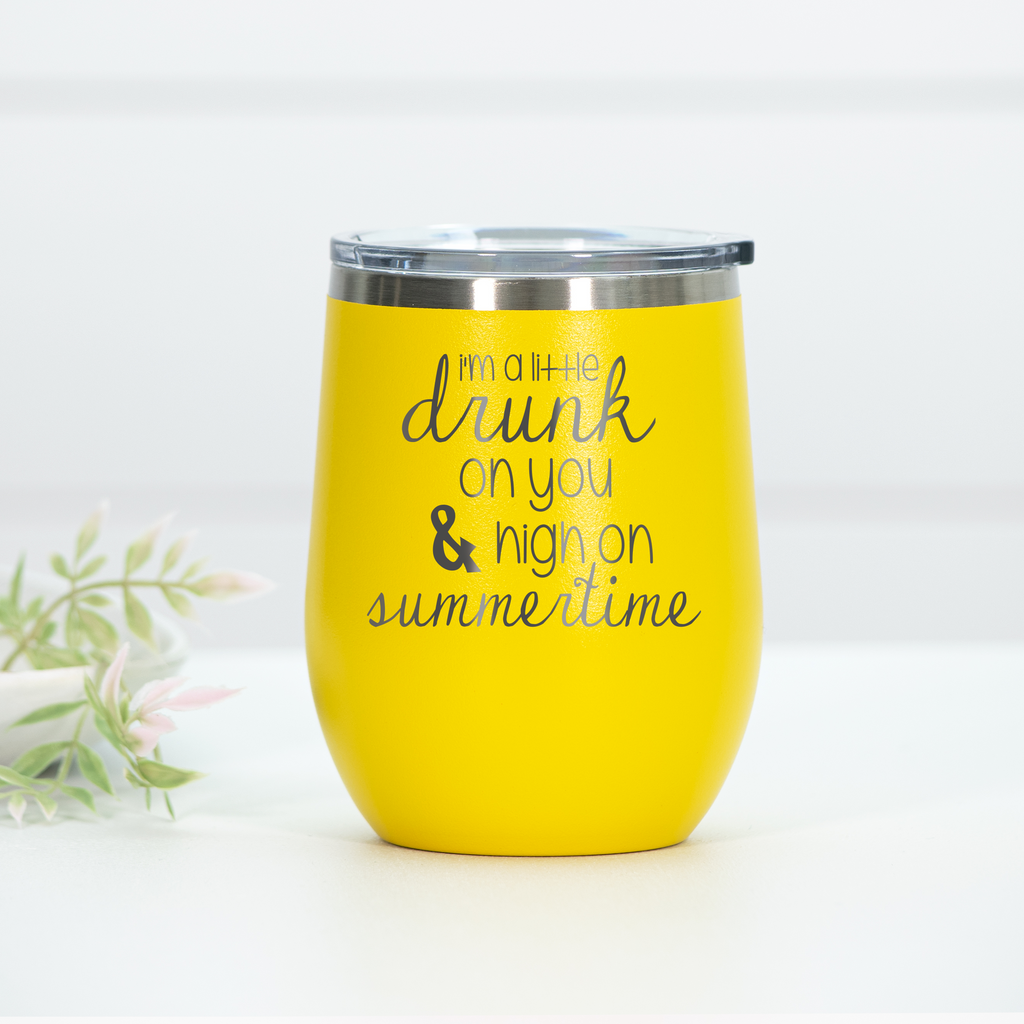 Bright yellow stainless steel wine tumbler featuring the engraved text 'I'm a little drunk on you & high on summertime' with a clear lid.