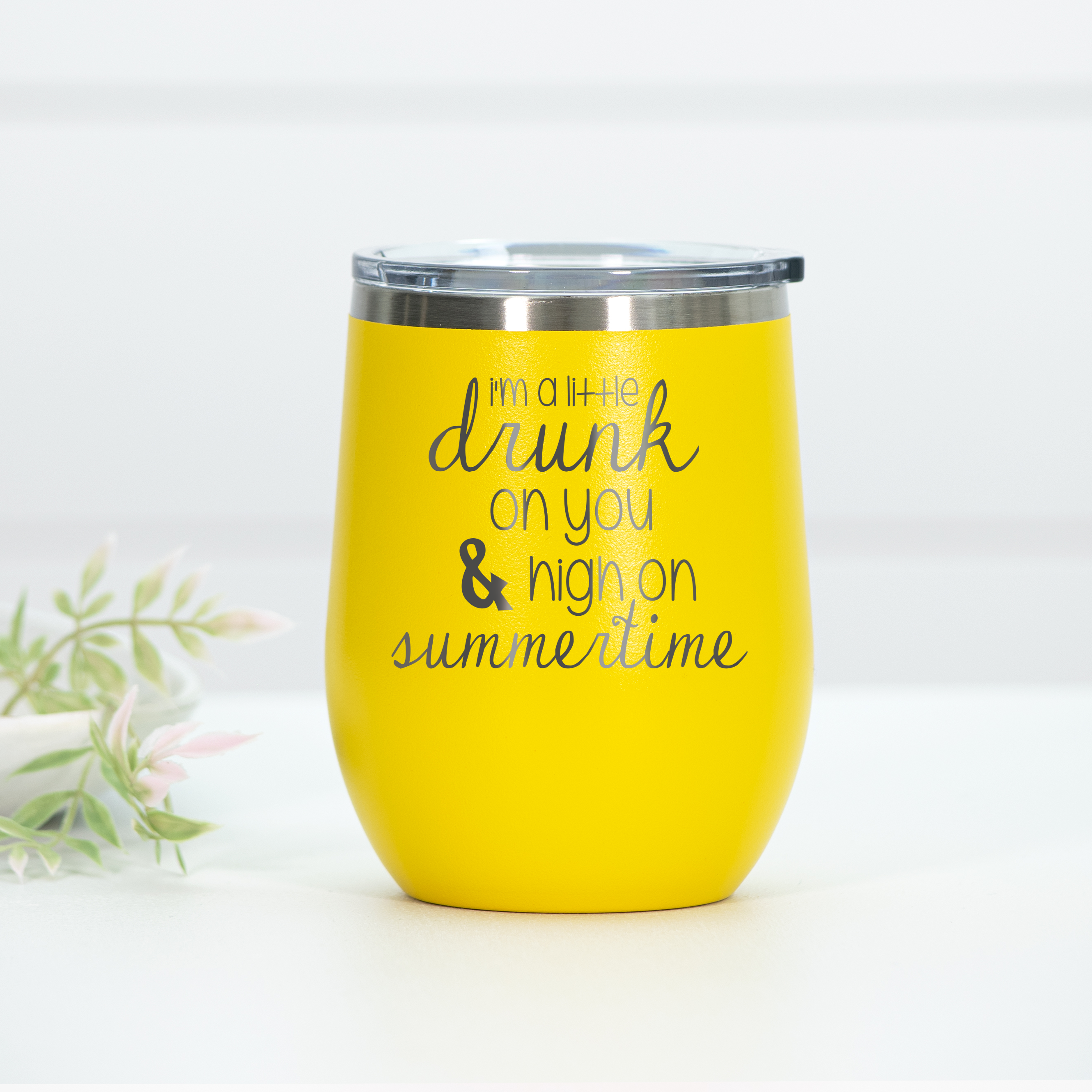 Bright yellow stainless steel wine tumbler featuring the engraved text 'I'm a little drunk on you & high on summertime' with a clear lid.