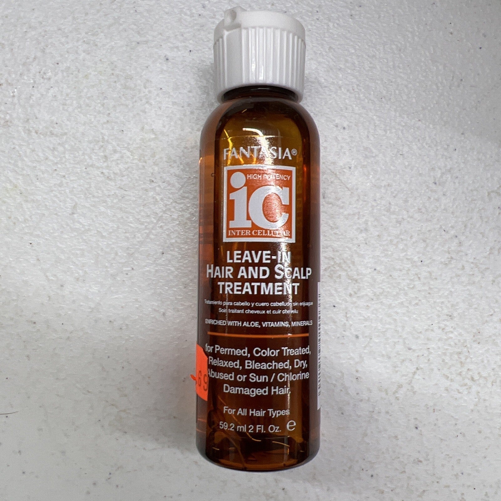 Fantasia IC Leave-In Hair and Scalp Treatment 2 oz bottle in brown and orange packaging.