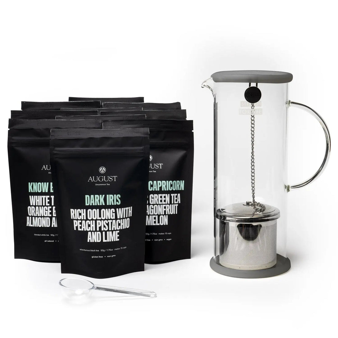 Collection of ten August Uncommon Tea black pouches with a glass iced tea brewer