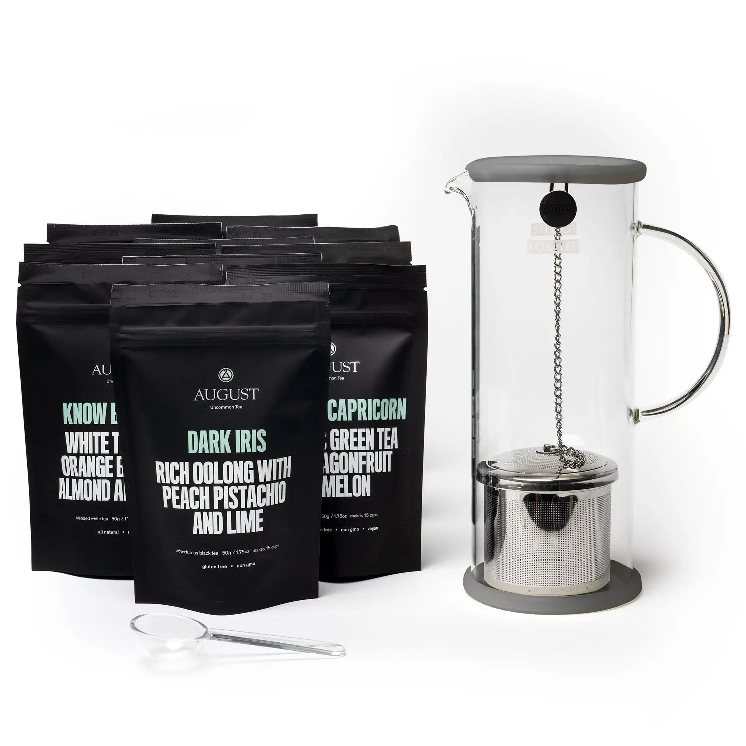 Collection of ten August Uncommon Tea black pouches with a glass iced tea brewer