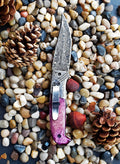 Classico Viola Damascus folding knife with walnut wood handle and silver blade.