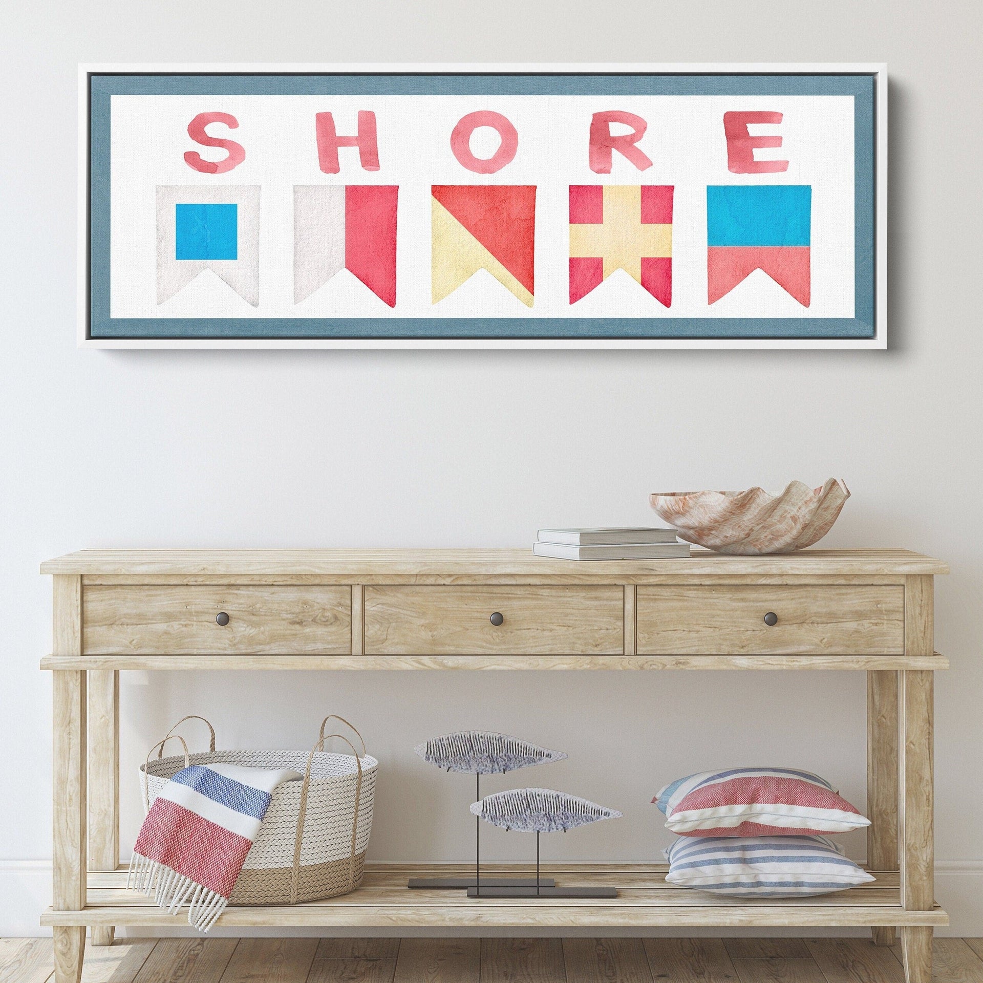 Shore House wall art sign featuring nautical signal flags in red, yellow, and blue on a framed canvas.