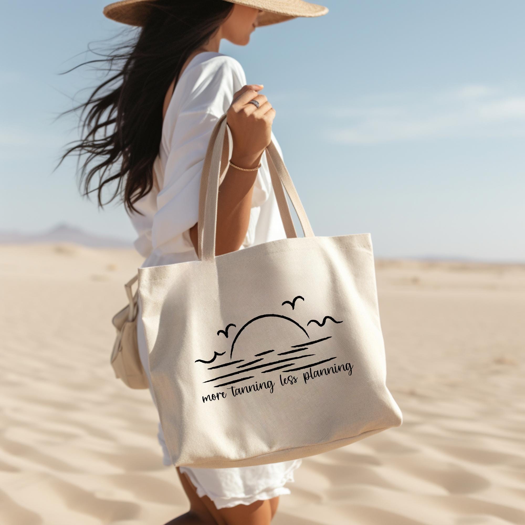 Woman holding a tote bag with a beach design in a desert setting