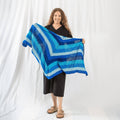 Close up of the I'm Feeling Plucky Tunisian Crochet shawl pattern featuring textured stitches and a decorative border.