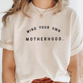 Mind Your Own Motherhood graphic crew neck in cream and black.