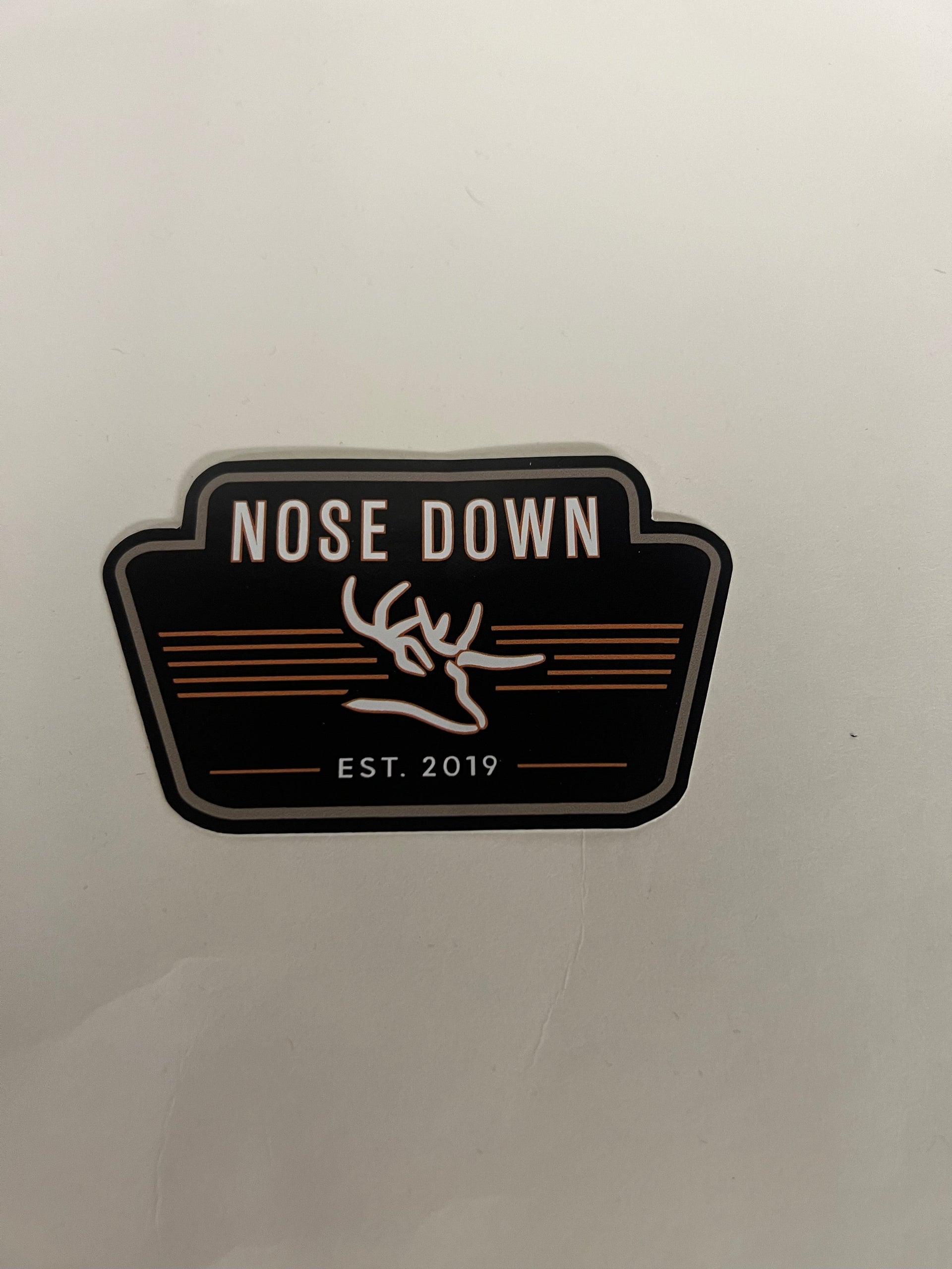 Nose Down branded high-contrast graphic decal in black, white, and red for outdoor gear