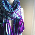 Bohemian striped knit scarf in purple, light blue, and turquoise made from recycled T-shirt yarn.