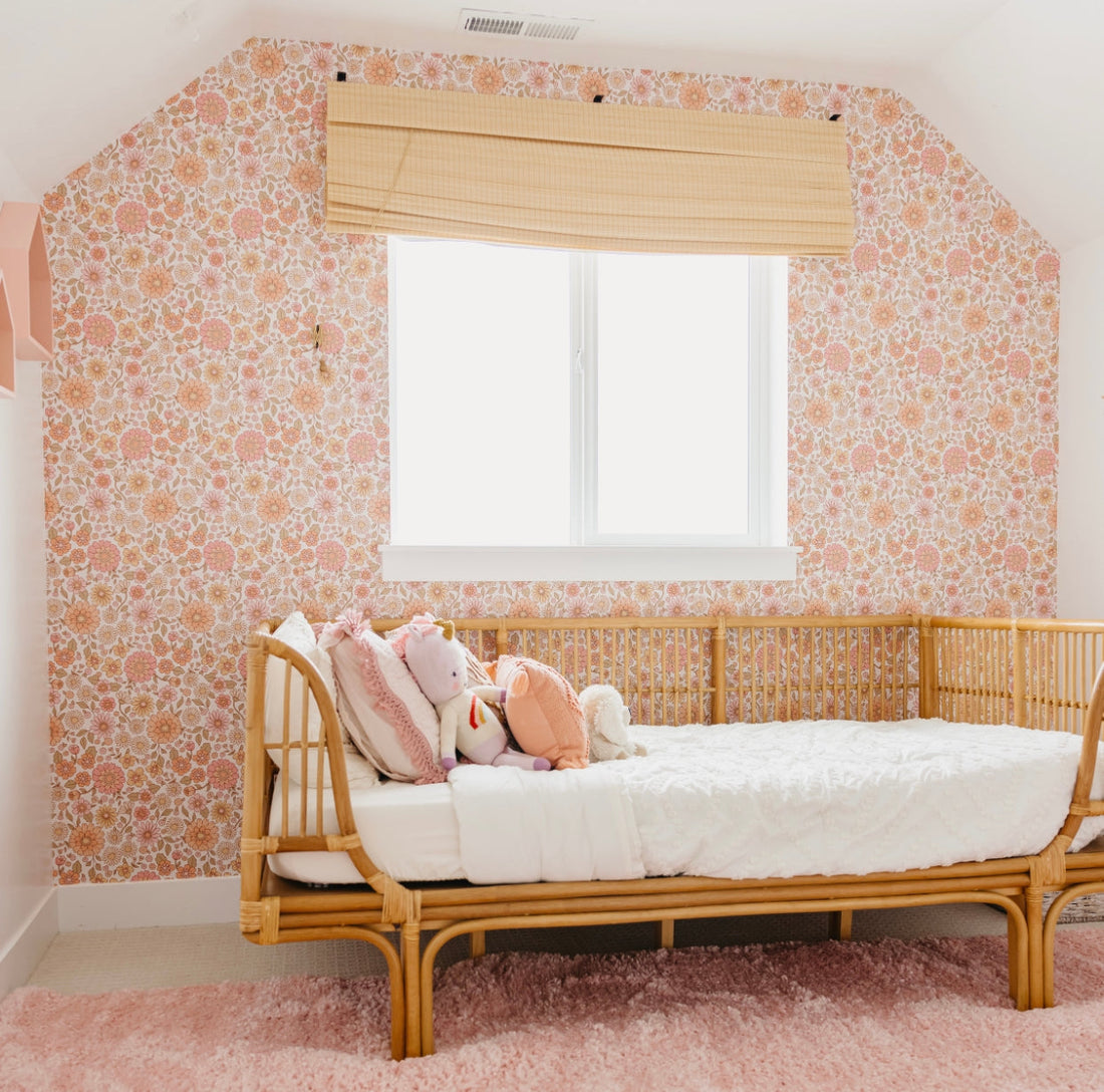 Daisy floral wallpaper in pink, peach, and tan hues for a bohemian vintage room.