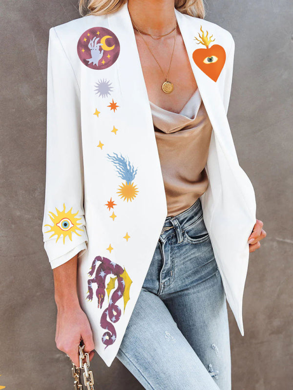 Back view of a woman wearing a white blazer with a celestial and snake graphic print, featuring sun and star motifs.