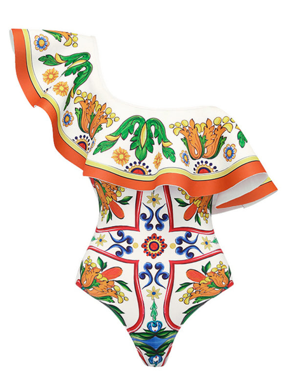 A vibrant one-shoulder ruffled floral print swimsuit displayed next to a matching sarong-style skirt cover-up on a plain white background.