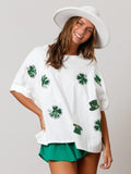 A woman wearing a festive St. Patrick's Day loose-fitting t-shirt with a sparkling sequined four-leaf clover design.
