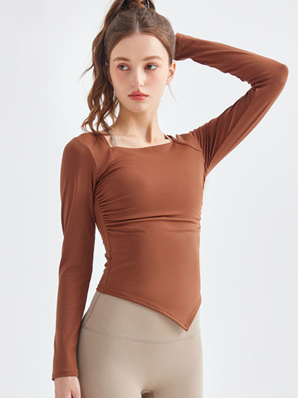 Woman wearing a brown long sleeve square collar sports top with an irregular hem during a workout.