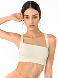 Cream colored square neck sports bra featuring a posture correction back design
