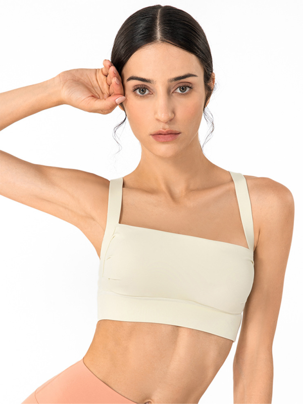 Cream colored square neck sports bra featuring a posture correction back design