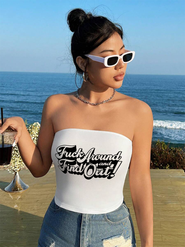 Close-up front view of a woman wearing a white strapless tube top with a red cherry print design.