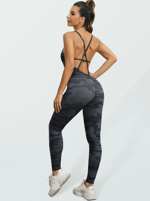 Woman wearing a black and grey camouflage athletic jumpsuit with cross-strap back detailing.