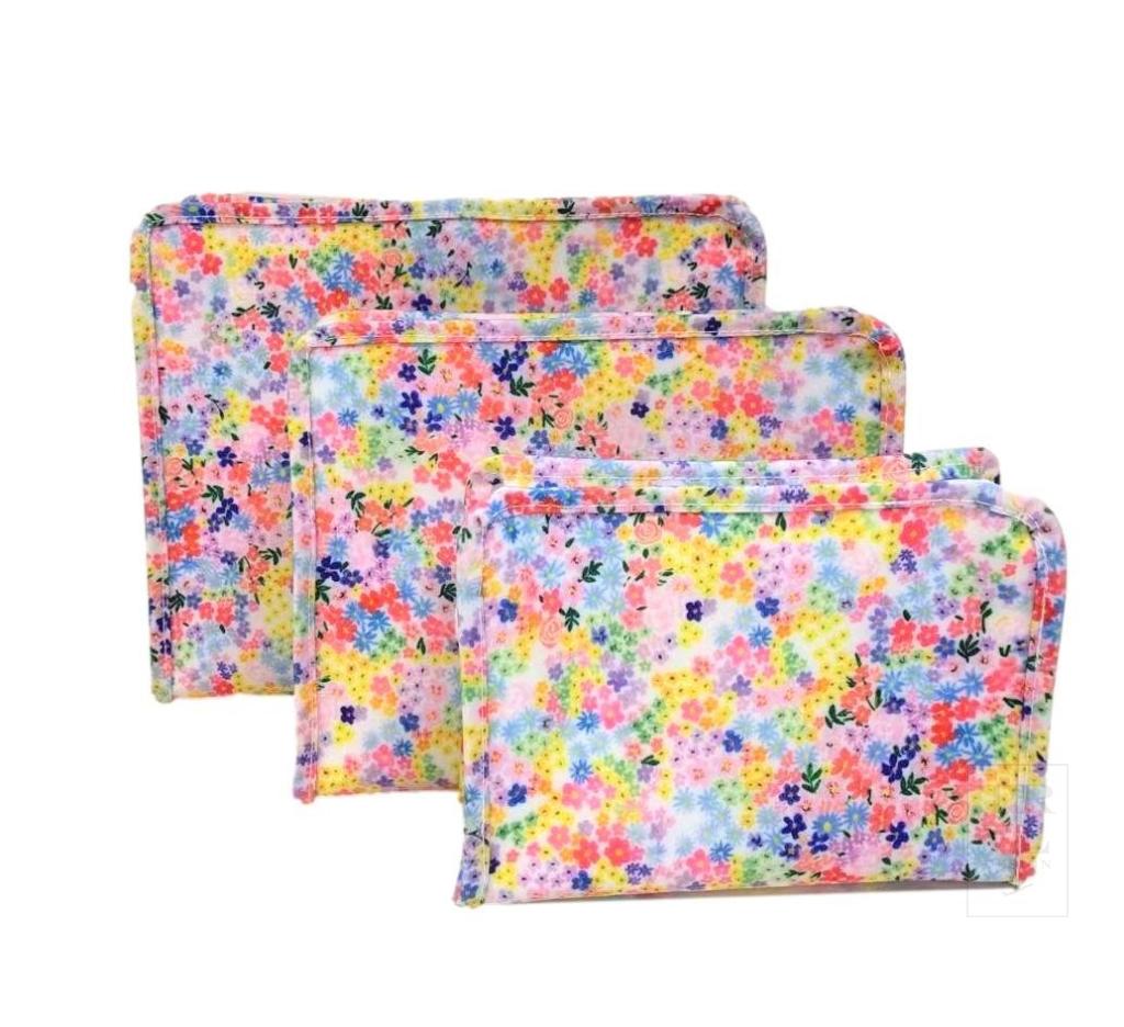 Three colorful floral-patterned bags stacked on a white background