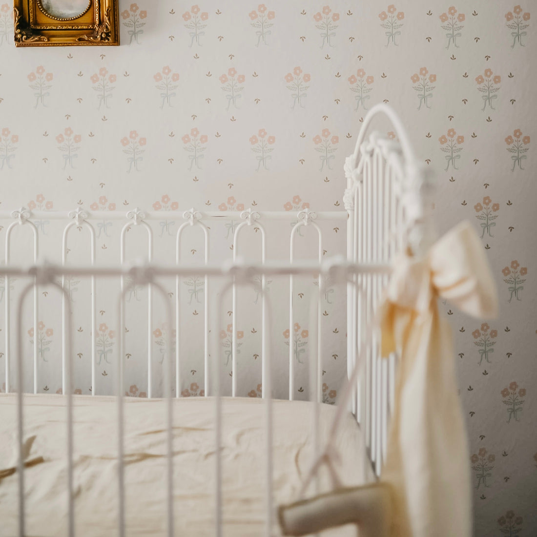 Clementine floral pattern wallpaper in white, pale-pink, and sage-green for vintage cottagecore interior.