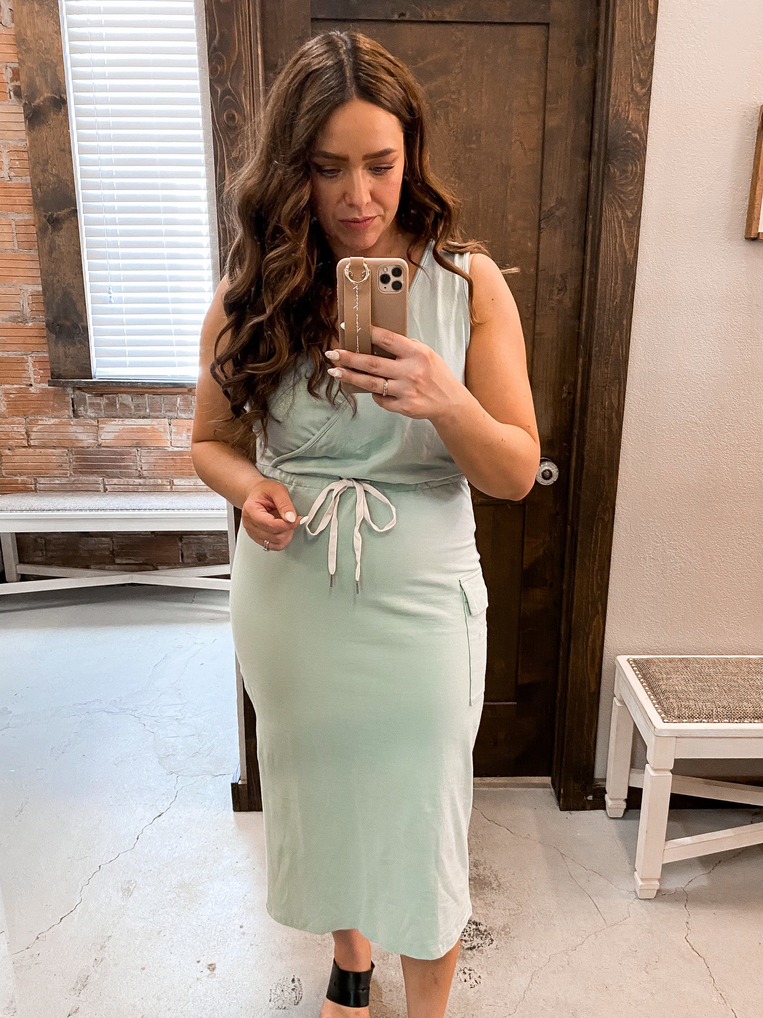 Close up of V-neck sleeveless dress with cross-front detail and flattering fit.