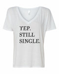 Close up of a casual graphic t-shirt with the text Yup, Still Single