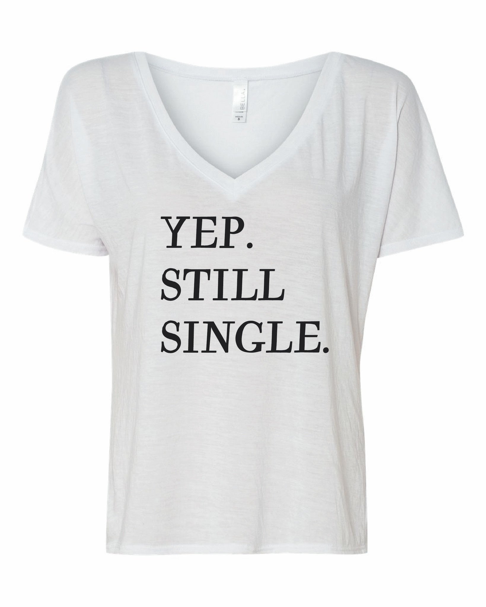 Close up of a casual graphic t-shirt with the text Yup, Still Single